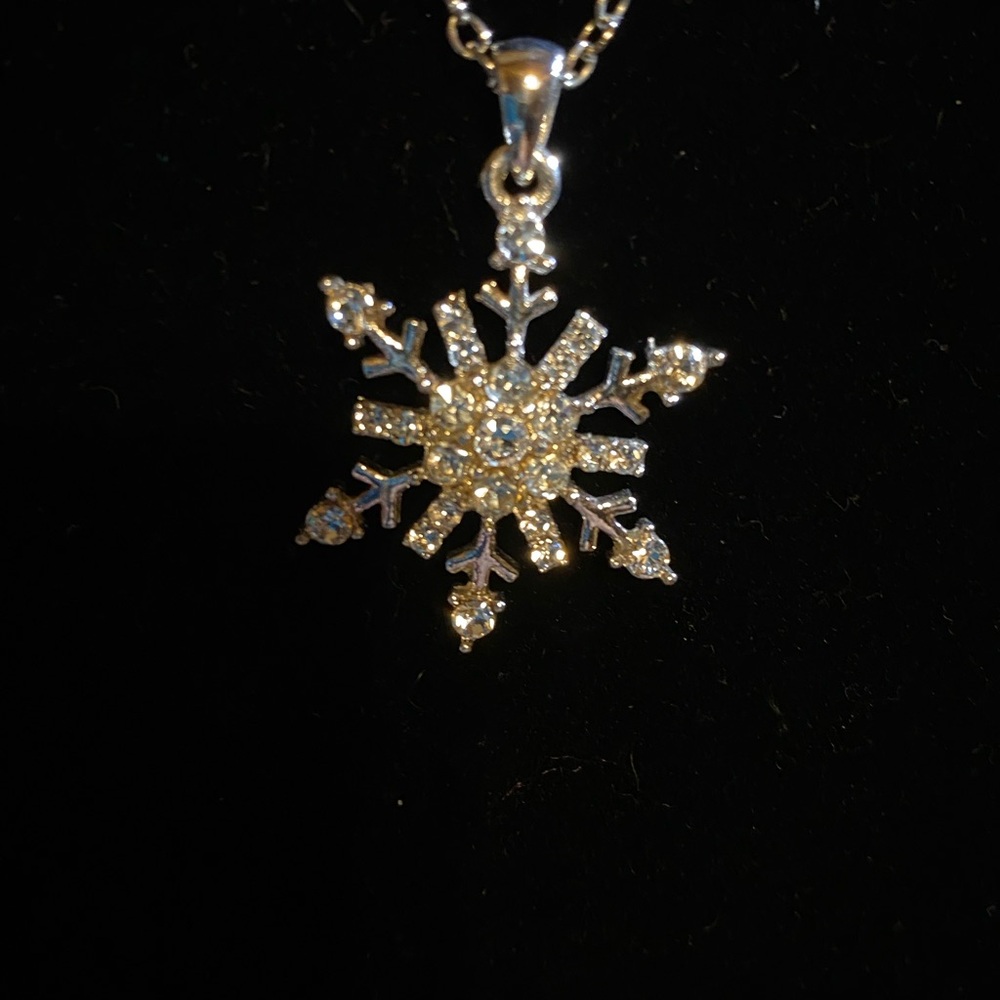 11” snowflake necklace. Silver tone rhinestone embellished.